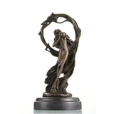 Art Nouveau bronze woman sculpture holding an orb, ethereal maiden statue with billowing gown and floral arch on black marble base, loss wax casting fine art.