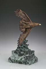 Bronze eagle sculpture with wings spread, capturing a powerful takeoff moment. A bold statue symbolizing strength, freedom, and ambition.