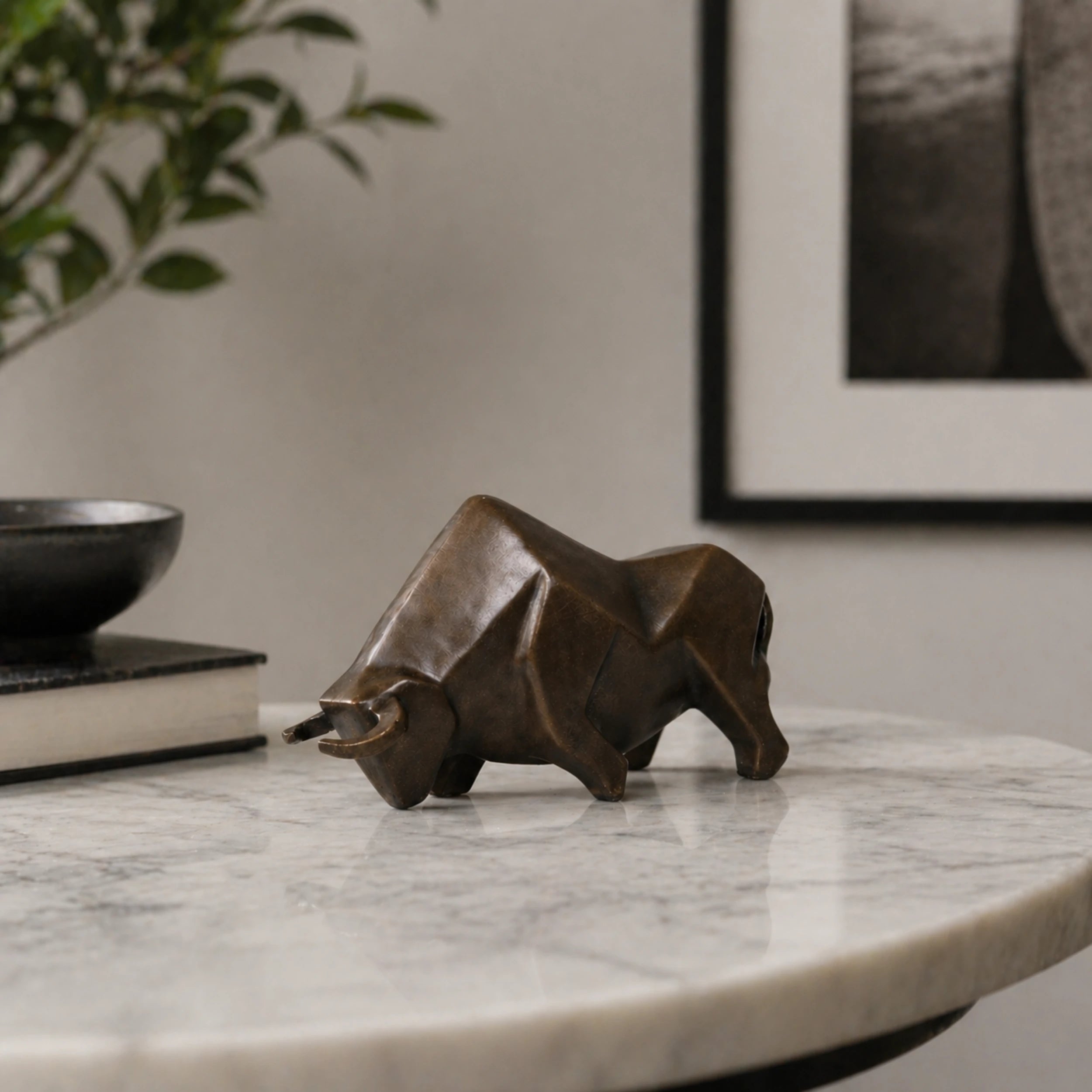 Cubist abstract bronze bull sculpture with geometric faceted planes, charging bull statue on black marble base, loss wax casting modern art.
