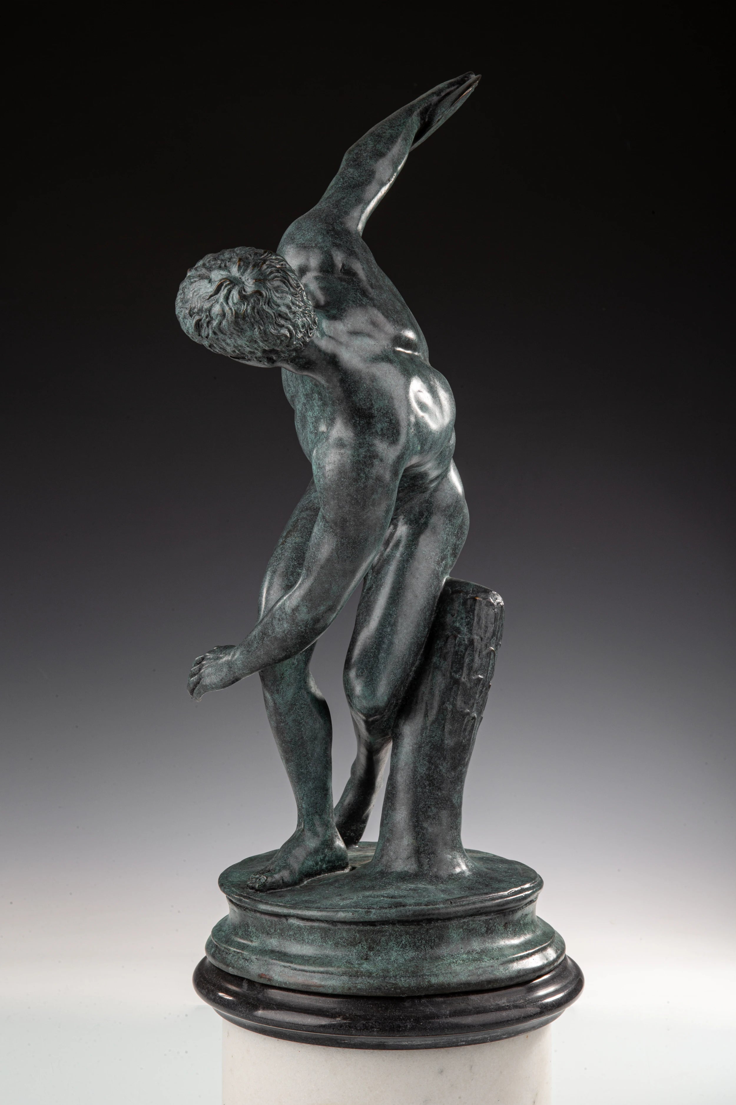 Classical Discobolus bronze statue of a discus thrower in a coiled pose, realistic ancient Greek athlete statue on tiered black marble base, loss wax casting fine art.