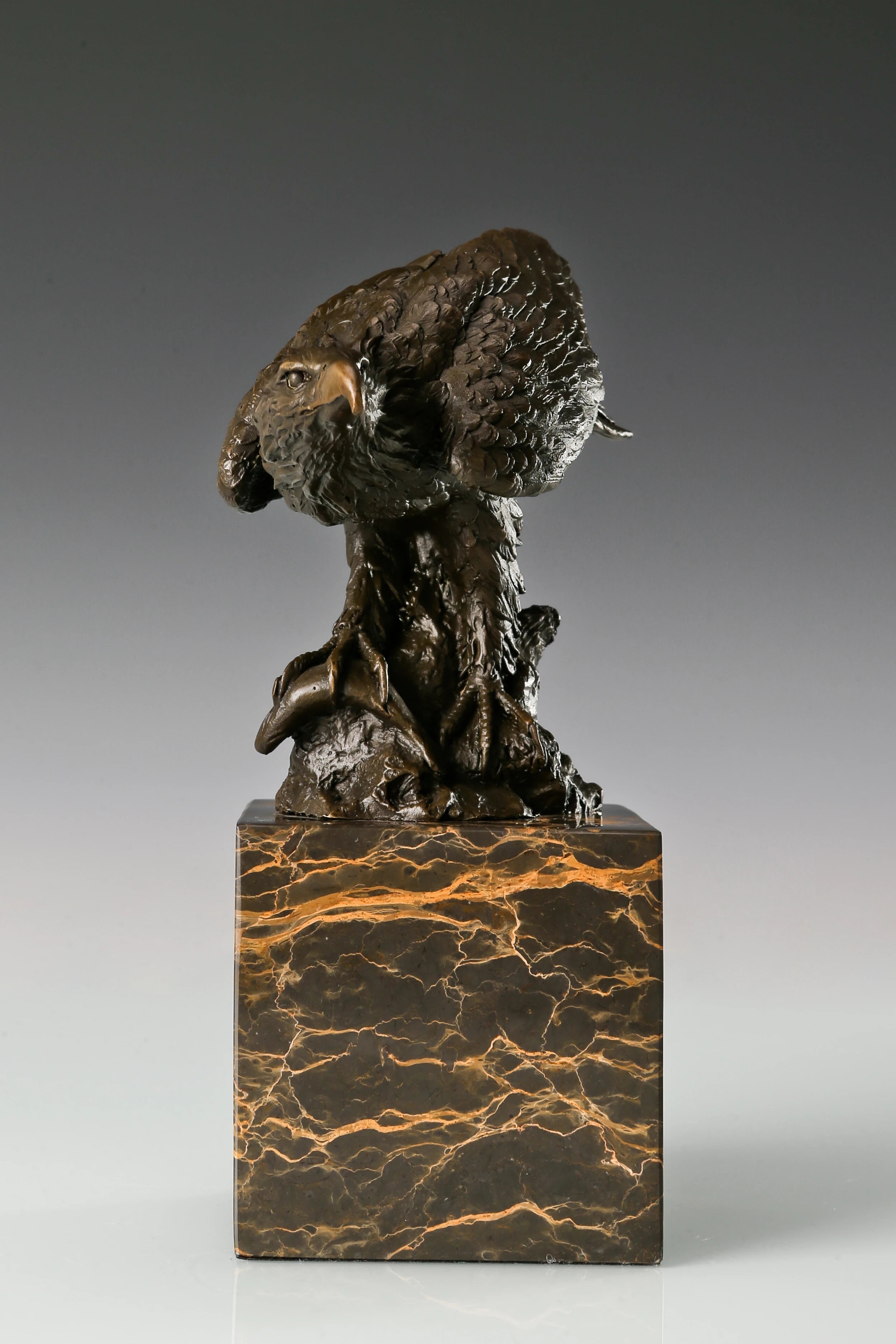 Pre-flight bronze eagle sculpture with detailed feathers and natural base. Elegant wildlife statue for home decor, office, or collectors.