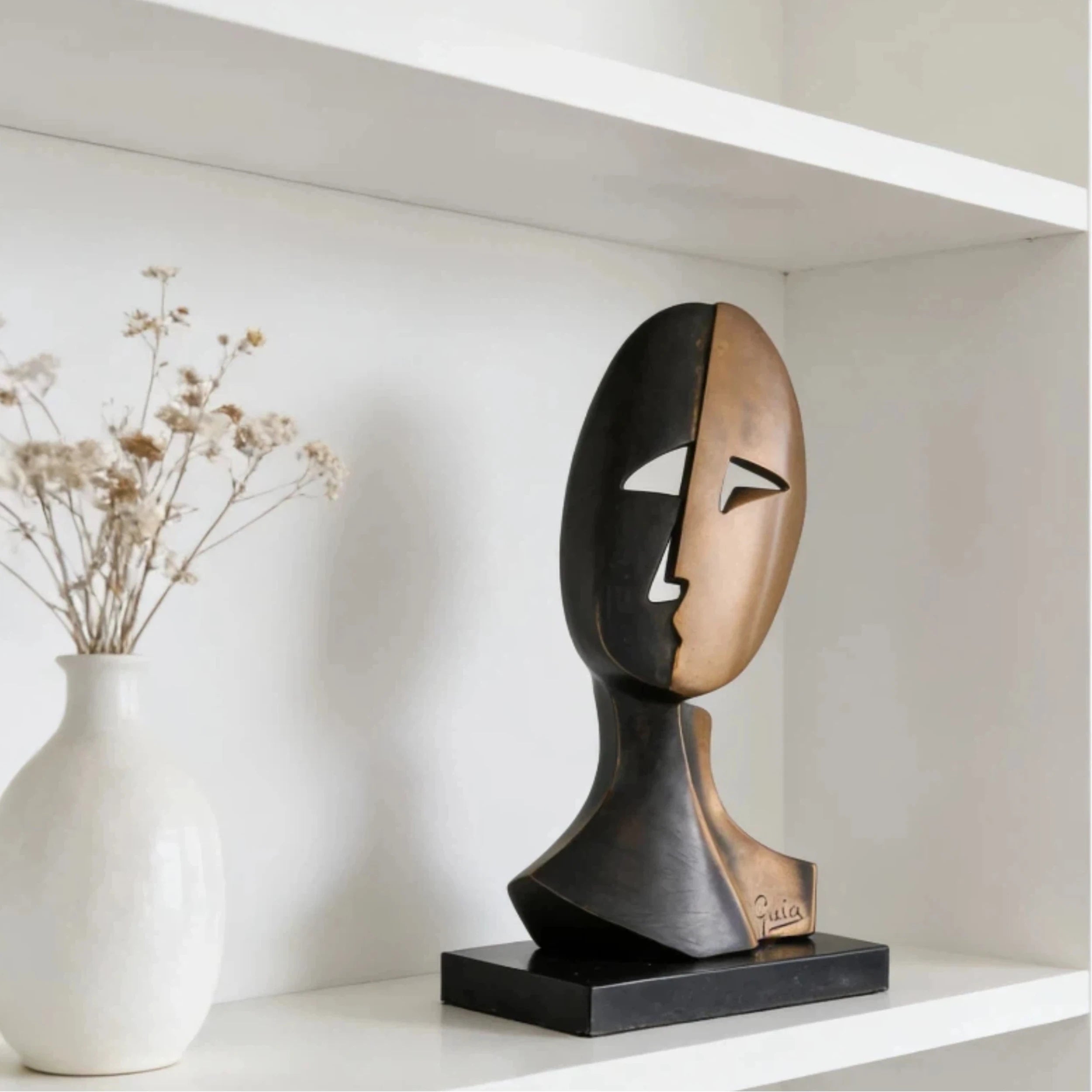 Modern abstract bronze split-face bust sculpture, signed Guia Cubist style art, black and warm bronze two-tone patina on polished plinth.
