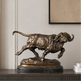 Realistic charging Cape buffalo bronze sculpture with warm brown patina, African wildlife animal statue on black marble base, loss wax casting fine art.