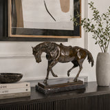 Saddled bronze horse statue with detailed tack and dark patina, realistic walking equestrian sculpture on veined black marble base, loss wax casting fine art.