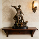 Saint Michael the Archangel bronze statue vanquishing Satan, detailed Roman armor warrior angel sculpture on oval black marble base, loss wax casting religious art.