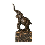 This is a dynamic bronze sculpture of an elephant calf, crafted using the lost-wax casting method and bearing the signature of the artist.