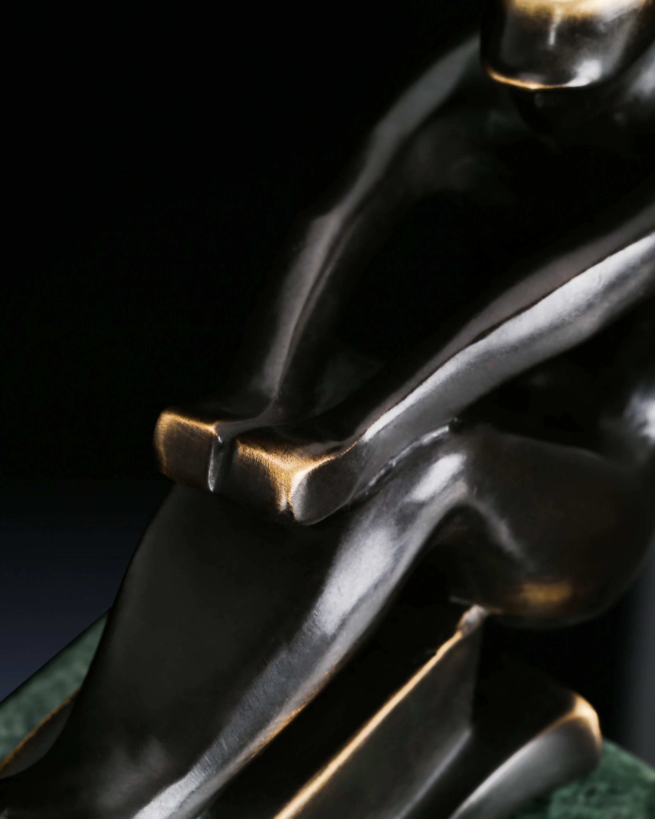 Close-up of stylized bronze sailboat hull with smooth contemporary curves
