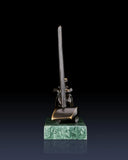 Rear view of abstract bronze sailing sculpture showing minimalist nautical composition
