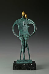 Front view of abstract couple bronze sculpture with two golden faces and heart-shaped arms