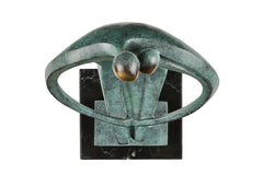 Overhead view of abstract couple bronze sculpture showing the two golden heads and curved arms