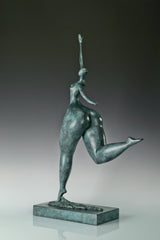 Angled view of modern abstract dancing woman bronze sculpture with green bronze patina