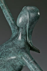 Close-up of abstract dancing woman bronze statue showing her head and hair
