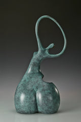 Back angled view of green patina abstract dancing woman sculpture