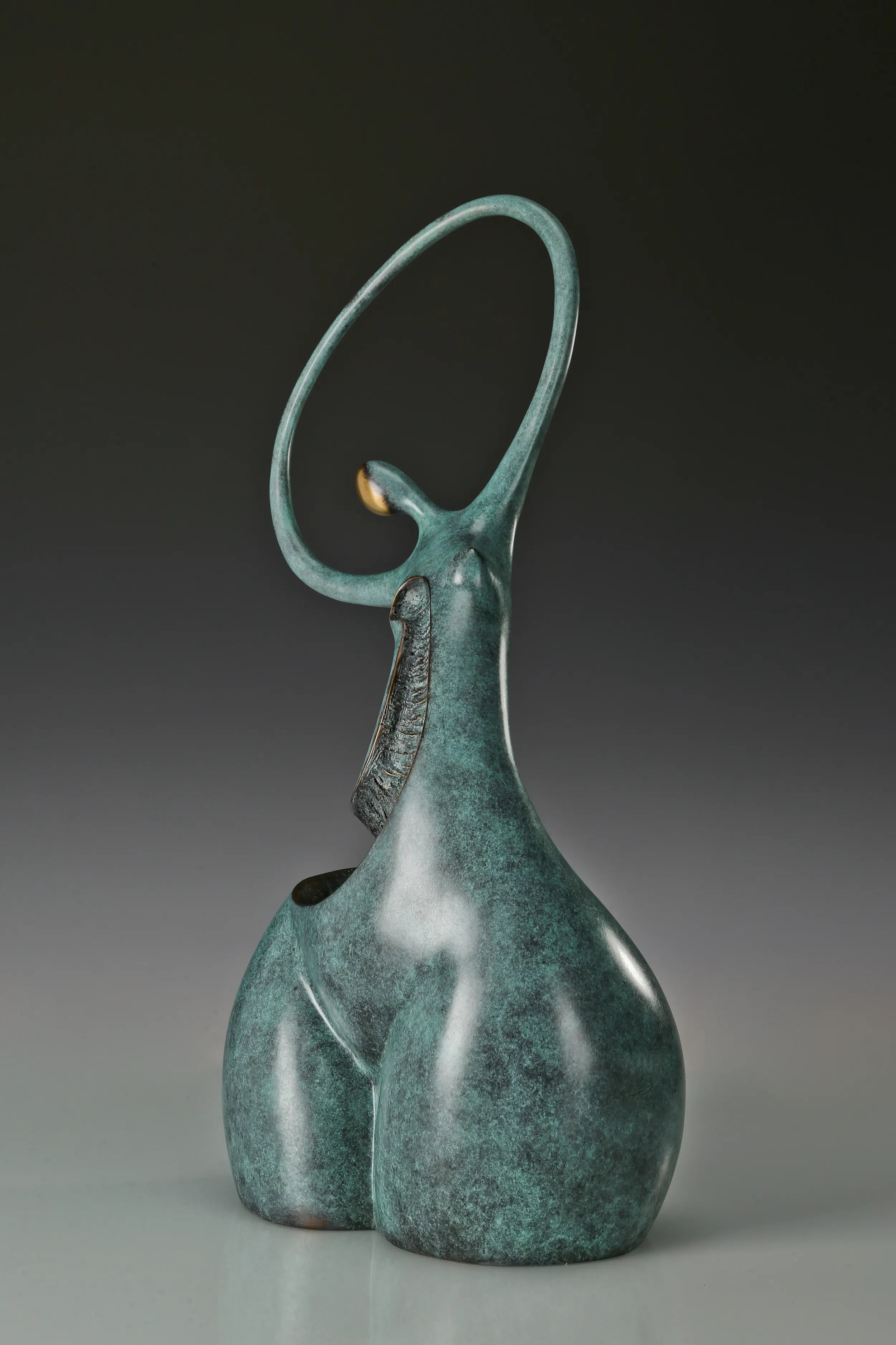 Rear three-quarter view of abstract dancing woman statue showing its sculptural curves