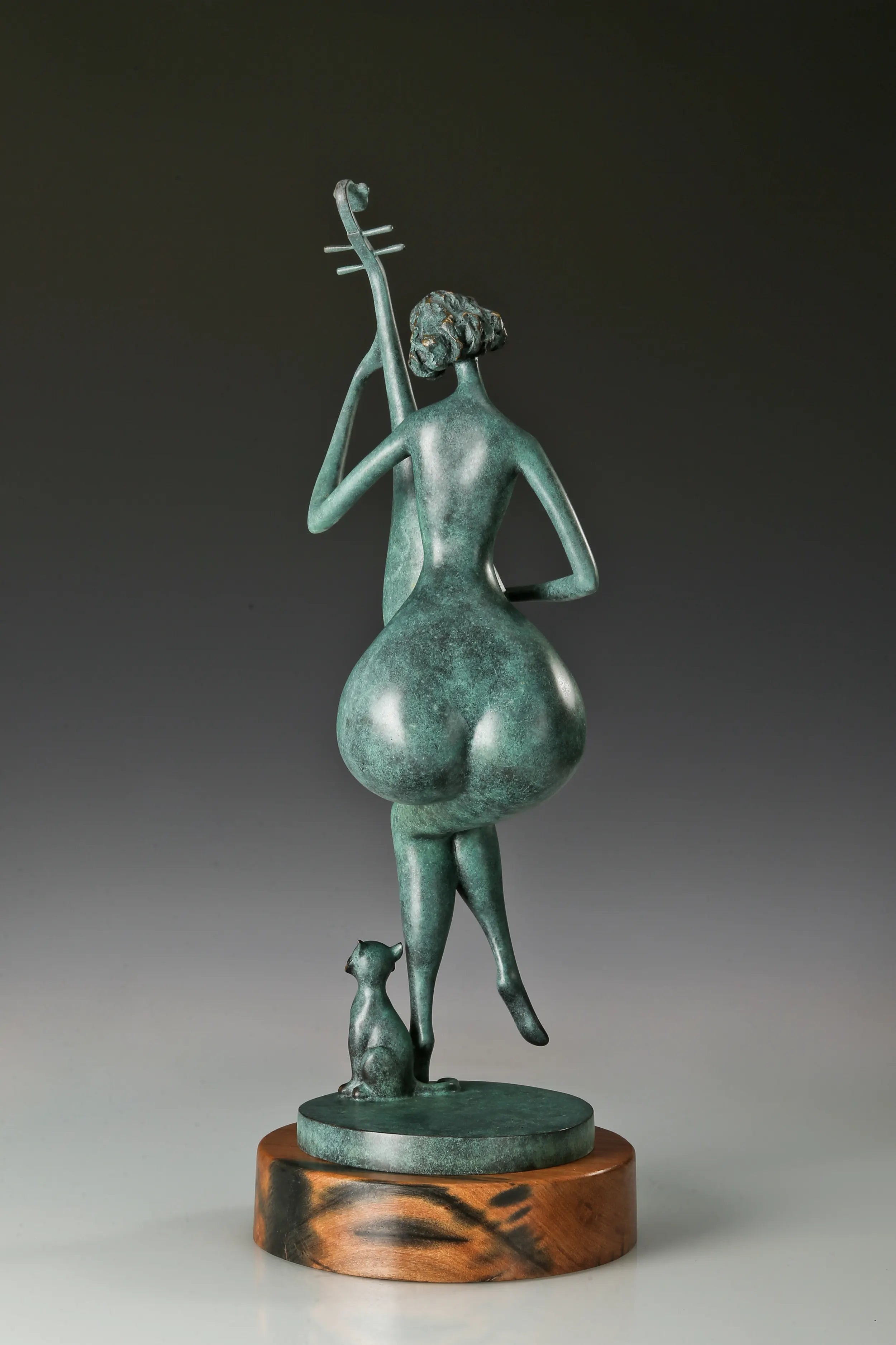 Rear view of the abstract female musician sculpture showing her seated pose and raised pipa