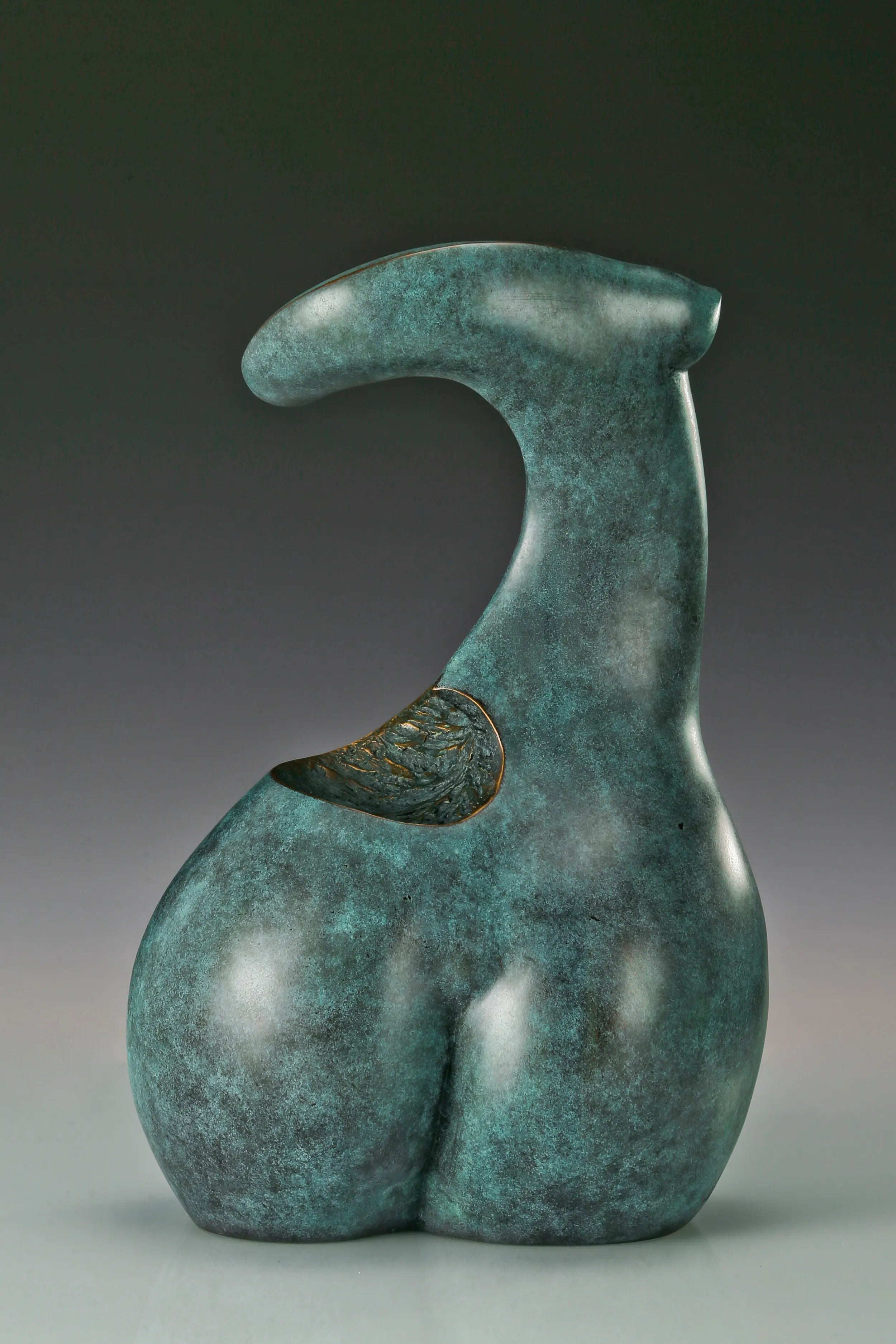 Rear view of abstract female torso bronze sculpture with rounded lower form