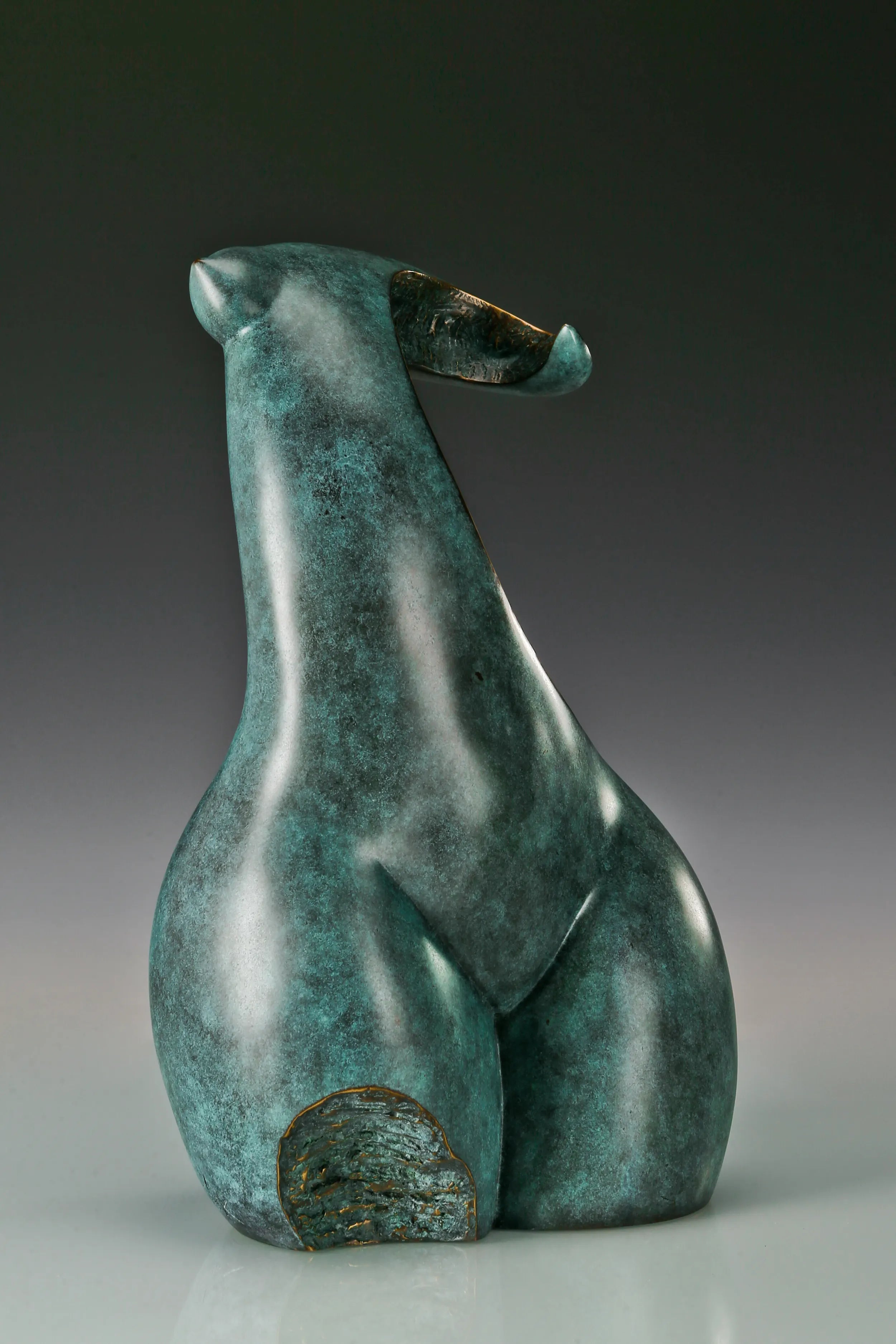 Opposite angled view of abstract female torso statue with curved neck and body