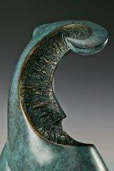 Close-up of textured bronze inset with gold-toned edges on abstract female sculpture