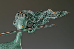 Close-up of the abstract woman's face, windswept hair, and horizontal flute