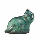 Abstract gazing cat bronze sculpture with green patina displayed in a modern home interior
