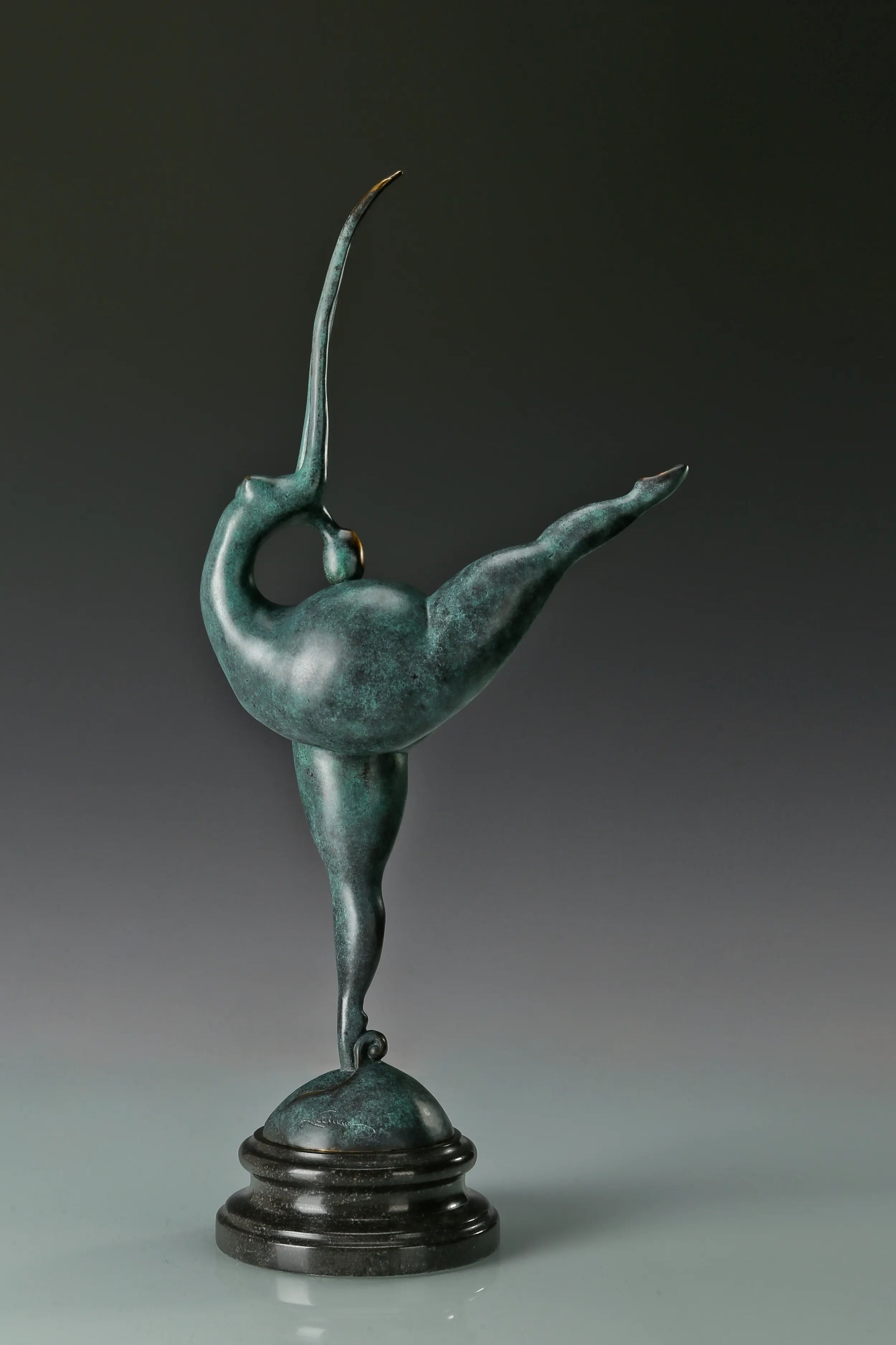 Opposite angled view of abstract gymnast sculpture with raised leg and green patina