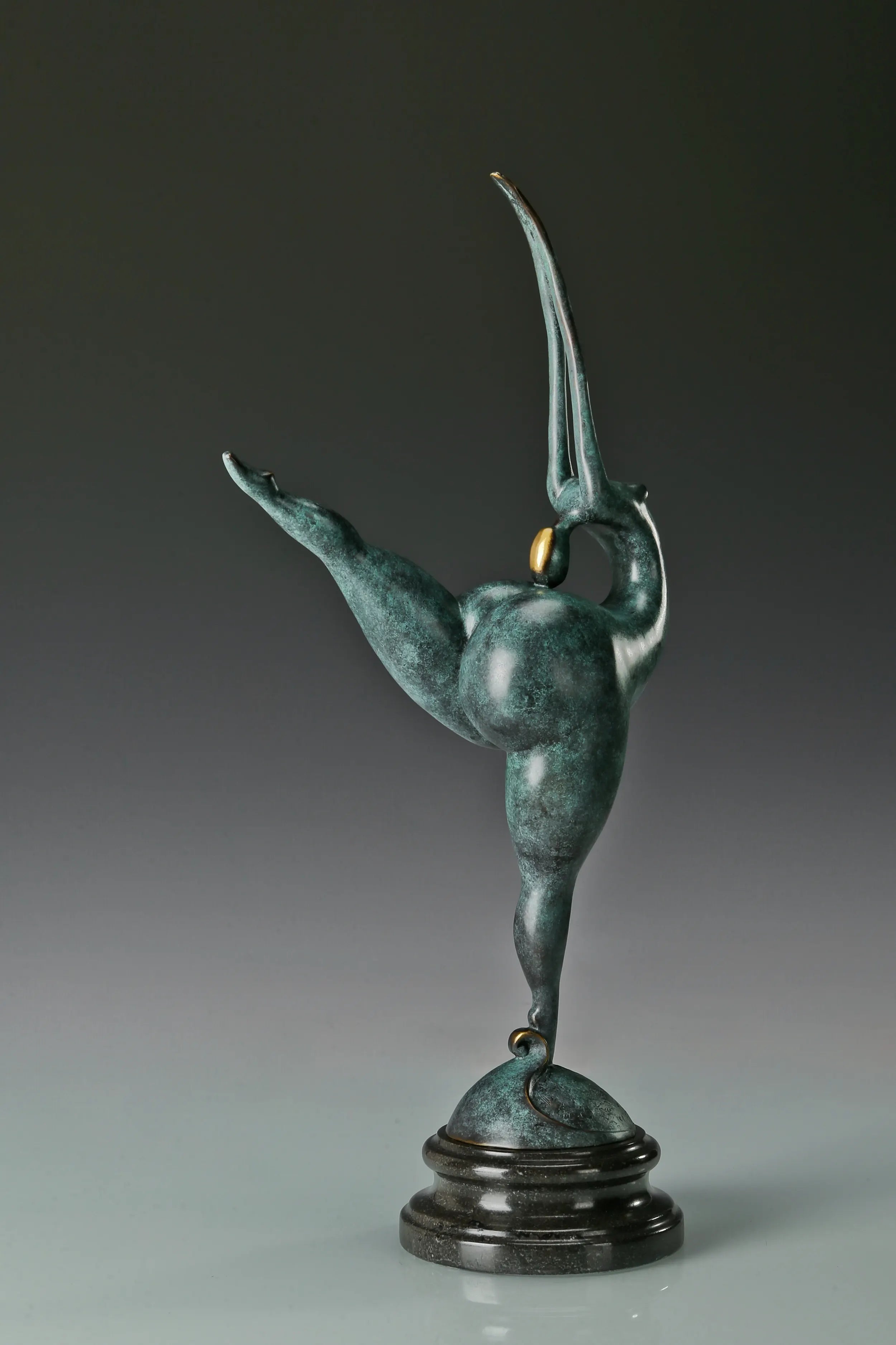 Side profile of abstract gymnast statue with elongated raised arms