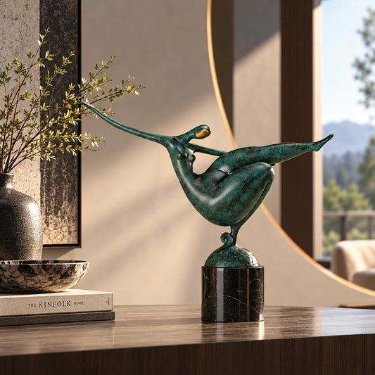Abstract gymnastics bronze sculpture with an arched body and extended leg displayed in a modern home interior