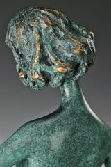 Close-up of the abstract female musician's softly tilted face and textured bronze hair
