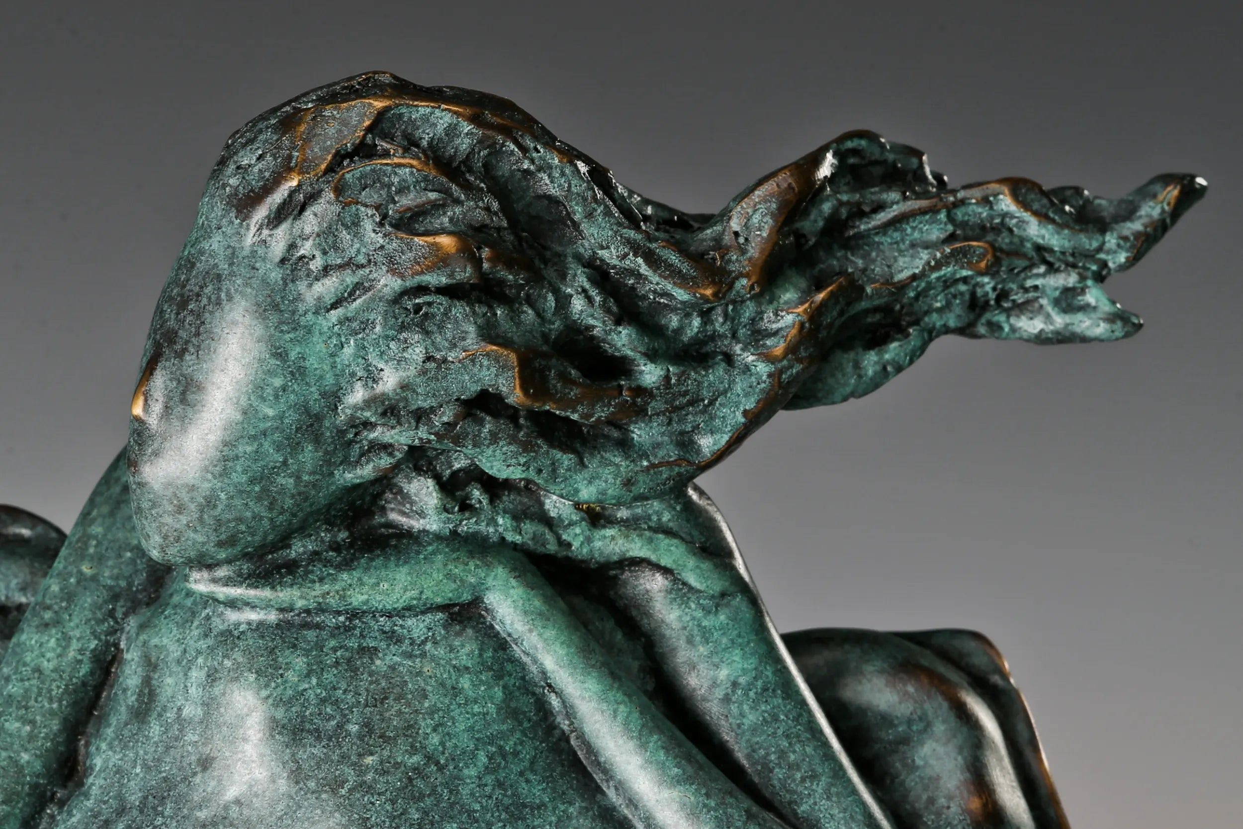 Close-up of the bronze woman's textured windswept hair and flowing cushion