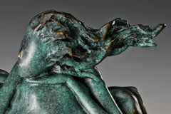 Close-up of the bronze woman's textured windswept hair and flowing cushion