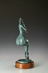 Opposite side view of the abstract seated woman bronze sculpture with green patina