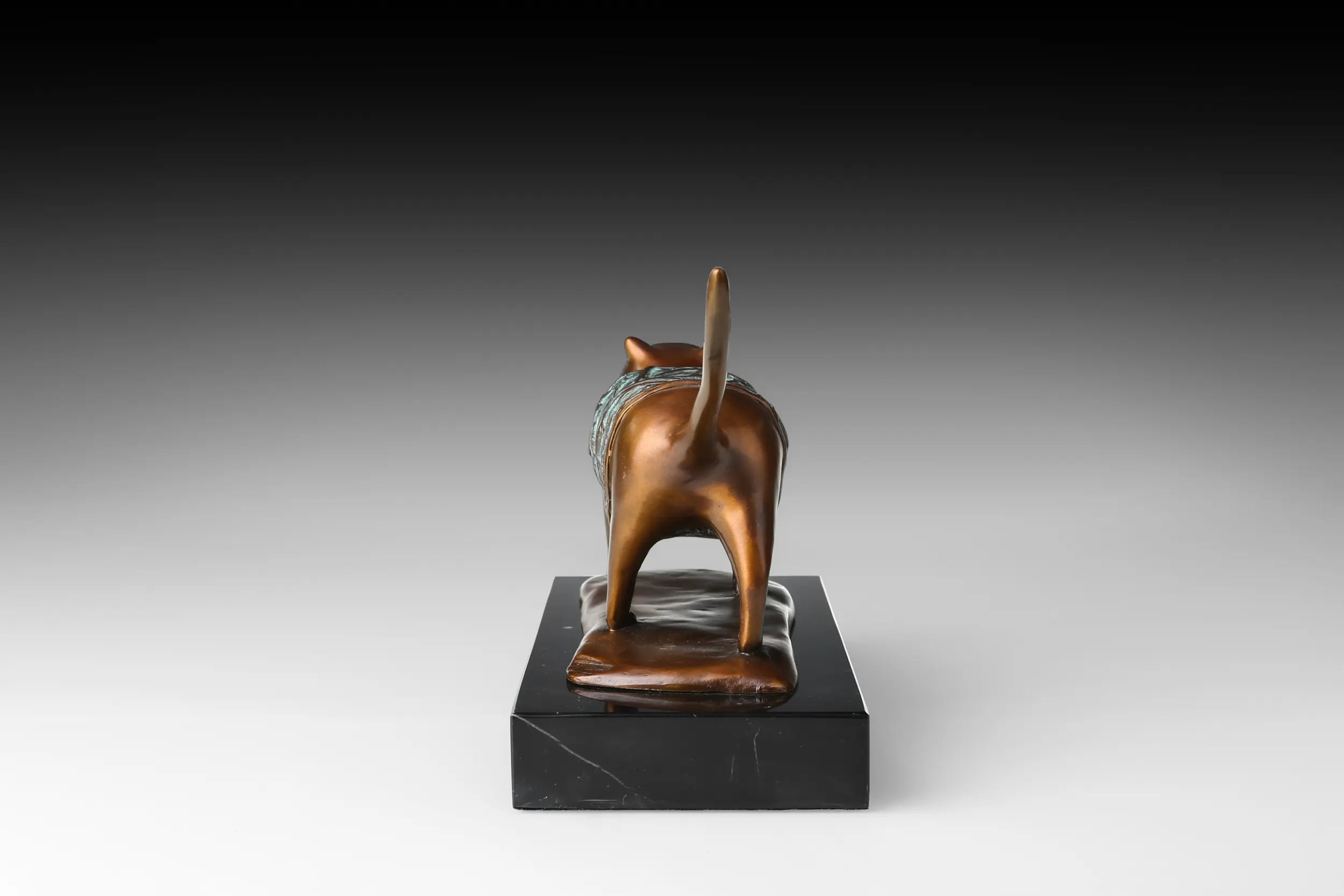Back view of handcrafted abstract walking cat bronze sculpture