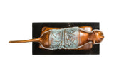 Raised tail and elongated form detail of modern bronze cat sculpture