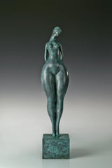 Full-length view of abstract female figure sculpture with a textured green bronze finish
