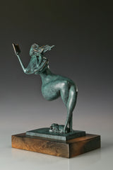 Angled view of an abstract woman reading a book with flowing hair and a green patina finish
