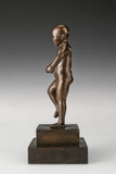 Left side view of bronze angry boy statue showing raised leg and clenched fist