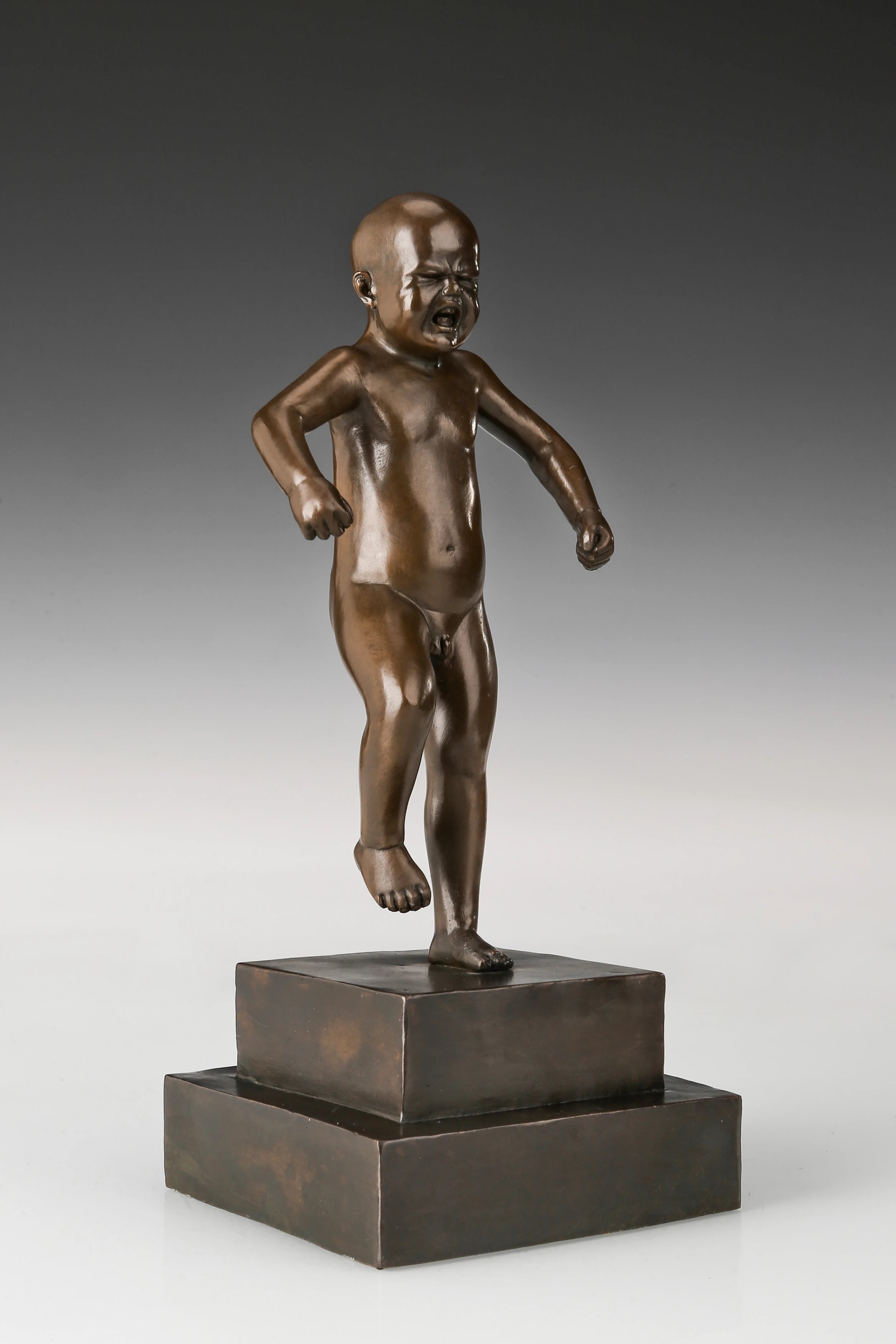 Handcrafted angry boy bronze statue with clenched fists and expressive face