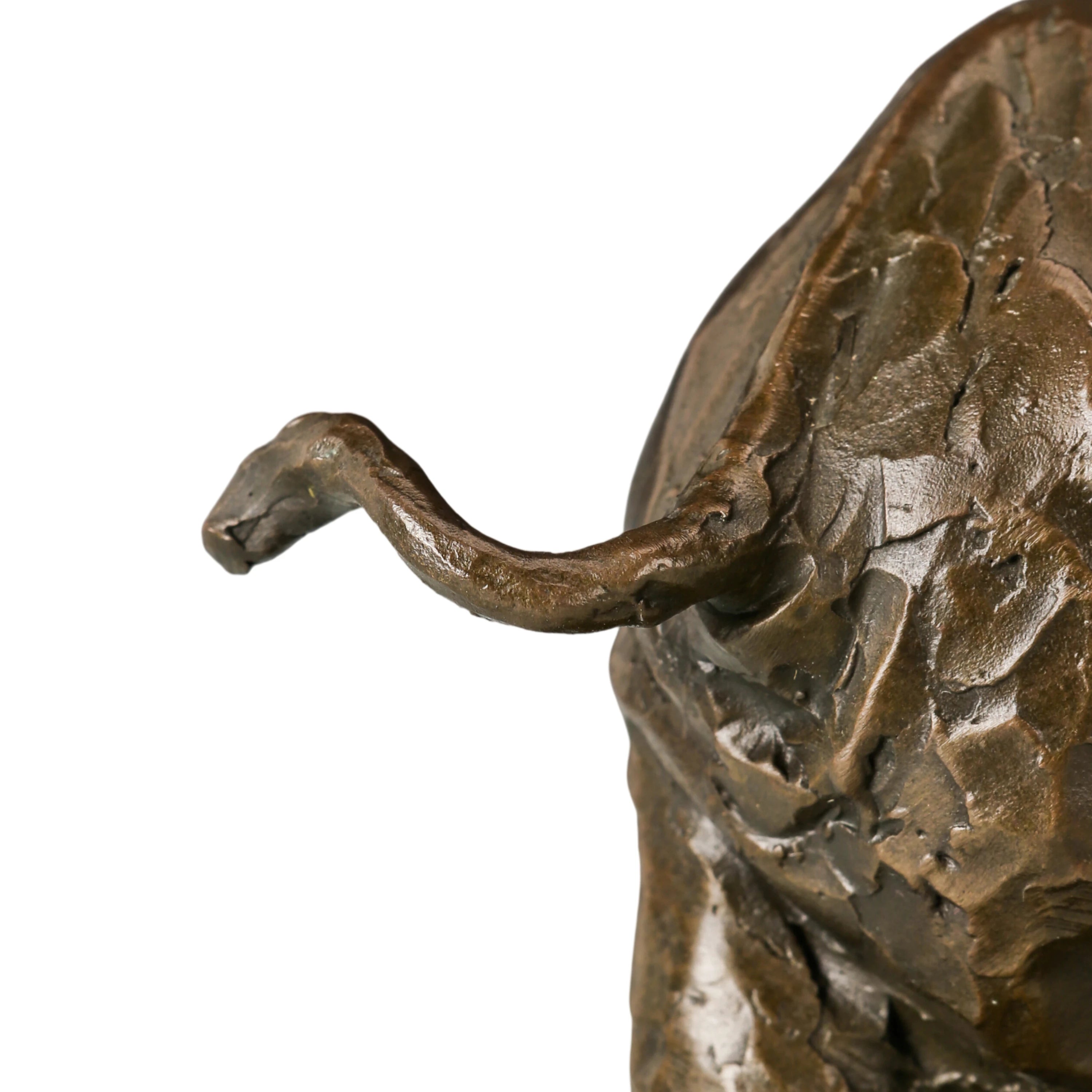 Dynamic bronze elephant sculpture featuring expressive texture and raised trunk. A striking wildlife statue symbolizing strength, resilience, and prosperity.