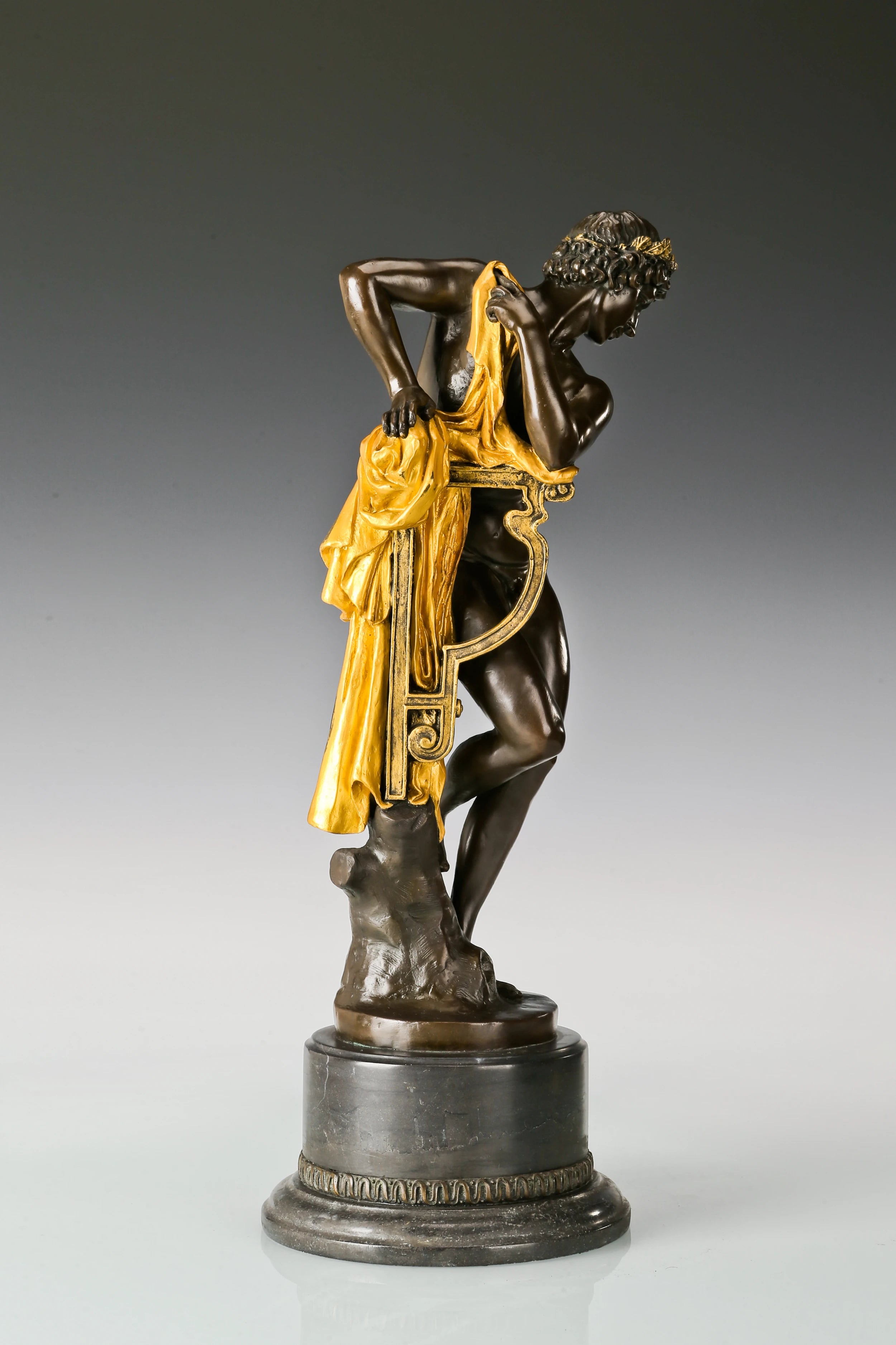 Detailed view of Apollo bronze sculpture with classical lyre