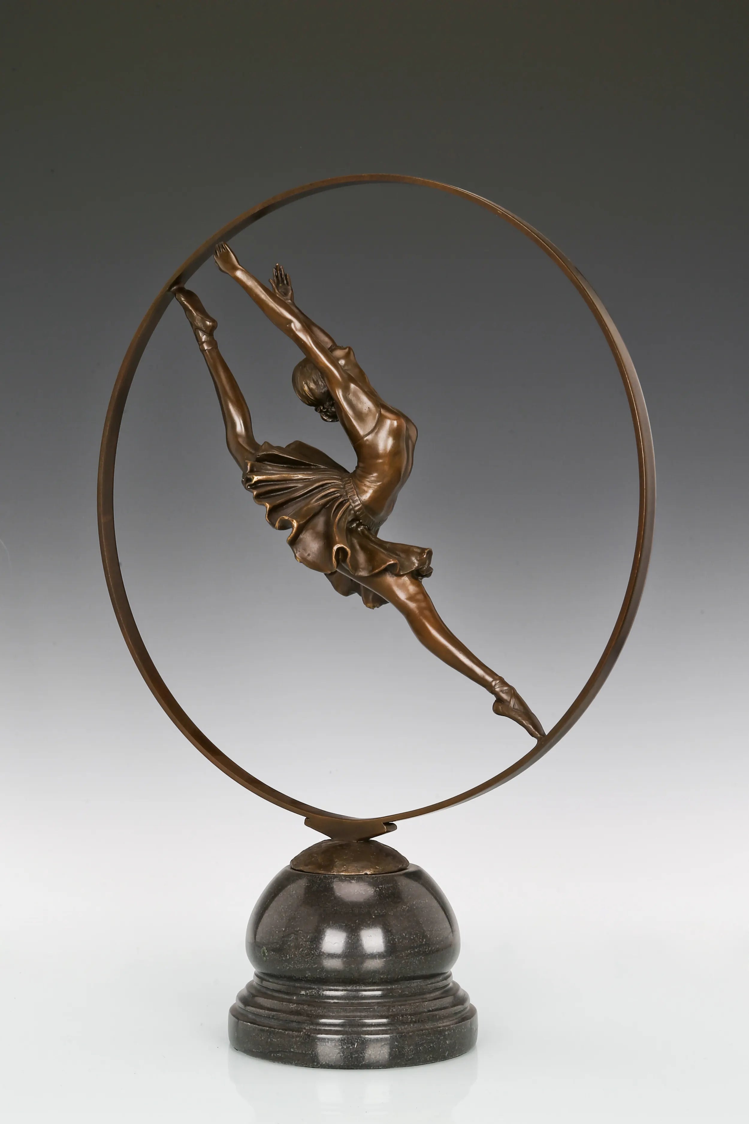 Full view of circular ballerina bronze statue on a polished black marble base