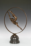 Full view of circular ballerina bronze statue on a polished black marble base
