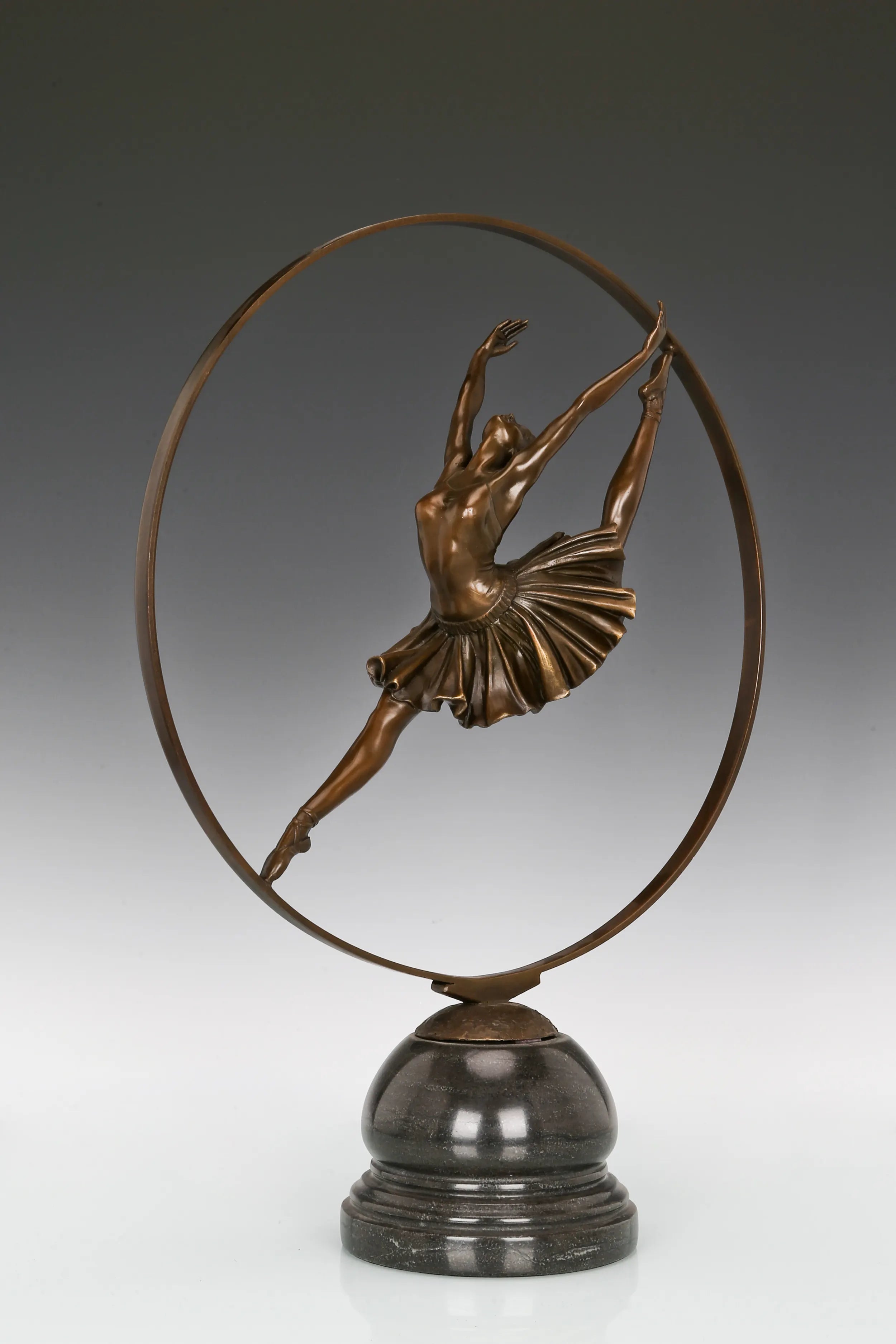 Left side view of ballerina bronze sculpture within a circular frame