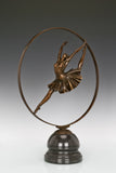 Left side view of ballerina bronze sculpture within a circular frame