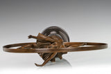 Circular bronze frame detail surrounding the leaping ballerina figure