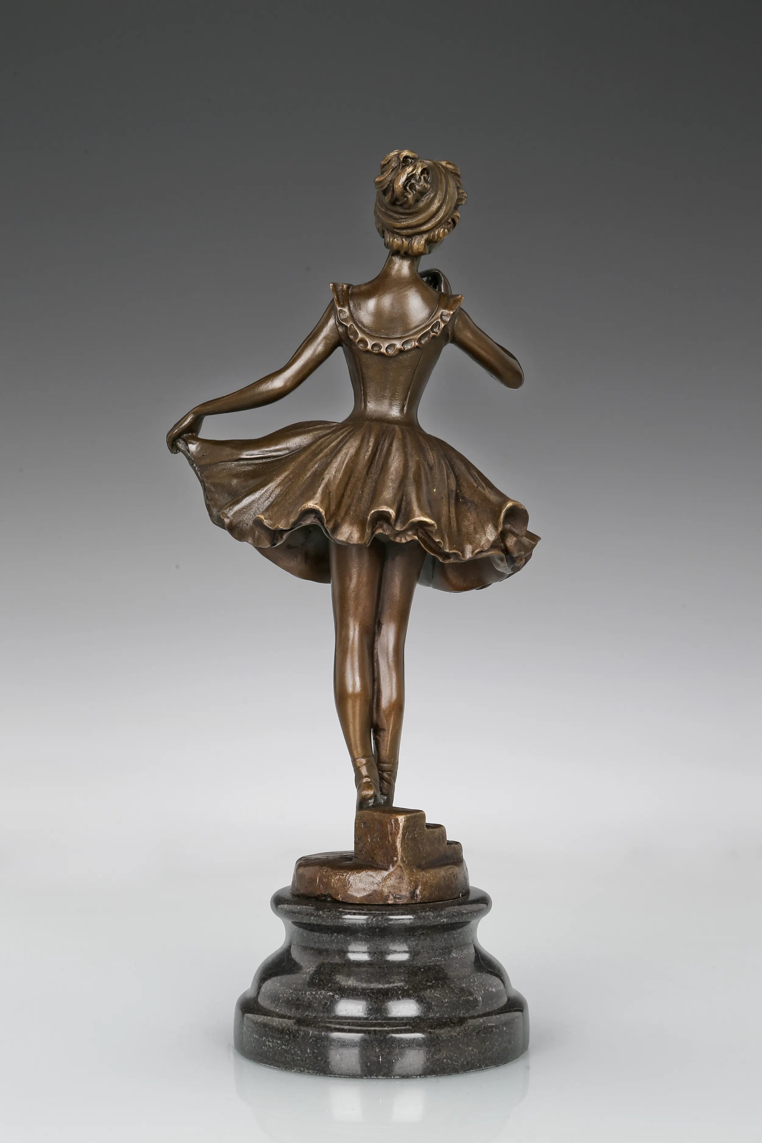 Back view of ballerina bronze sculpture showing the detailed ballet costume