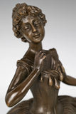 Close-up of the ballerina bronze sculpture showing her delicate facial expression