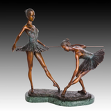 Front view of two ballerinas practicing at a ballet barre in a handcrafted bronze sculpture