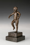 Three-quarter view of expressive bronze angry boy sculpture in a dramatic pose