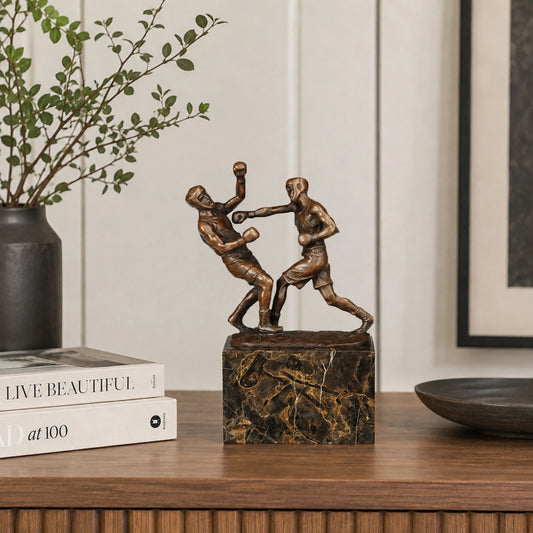 Bronze boxing fighters sculpture displayed as sports decor in a modern gym or boxing club