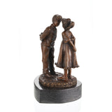 Front view of a handcrafted bronze boy and girl with flowers sculpture on a natural marble base.